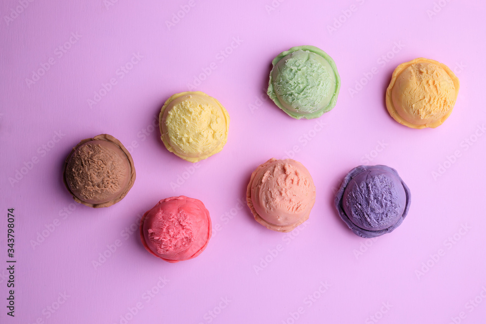 Set of ice cream scoops of different colors and flavors on pink table, copy space. Food background, summer refreshing concept, traditional seasonal cold sweets Set of ice cream scoops of different colors and flavors on pink table, copy space. Food background, summer refreshing concept, traditional seasonal cold sweets