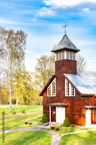 Small wooden church with bell tower in Virsuziglis in spring