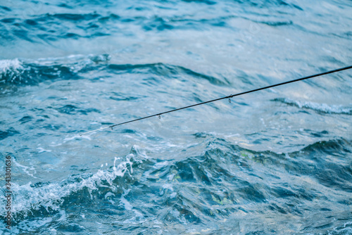 Fototapeta Naklejka Na Ścianę i Meble -  Fishing rod on the background of sea water. Fishing in Istanbul Turkey