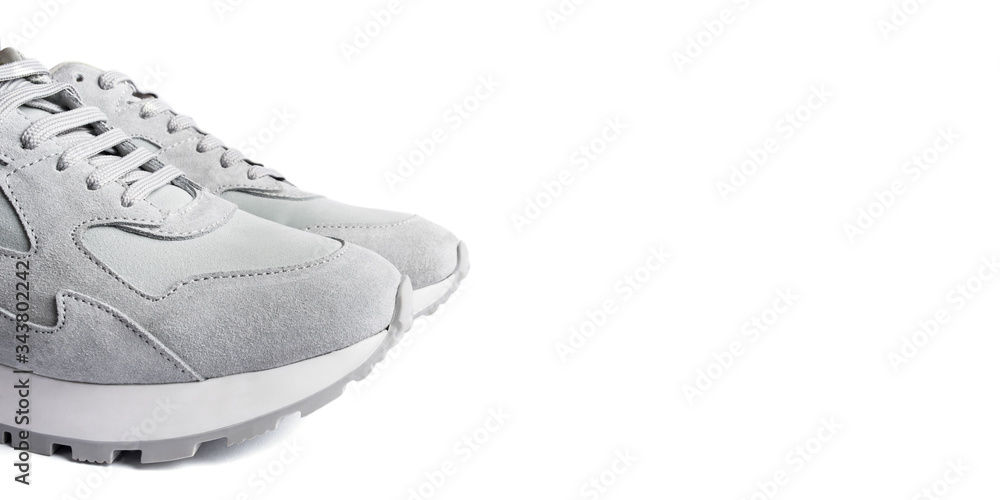 Gray sneakers isolated on white background. Copy space for text. Gray sneakers isolated on white background. Copy space for text.