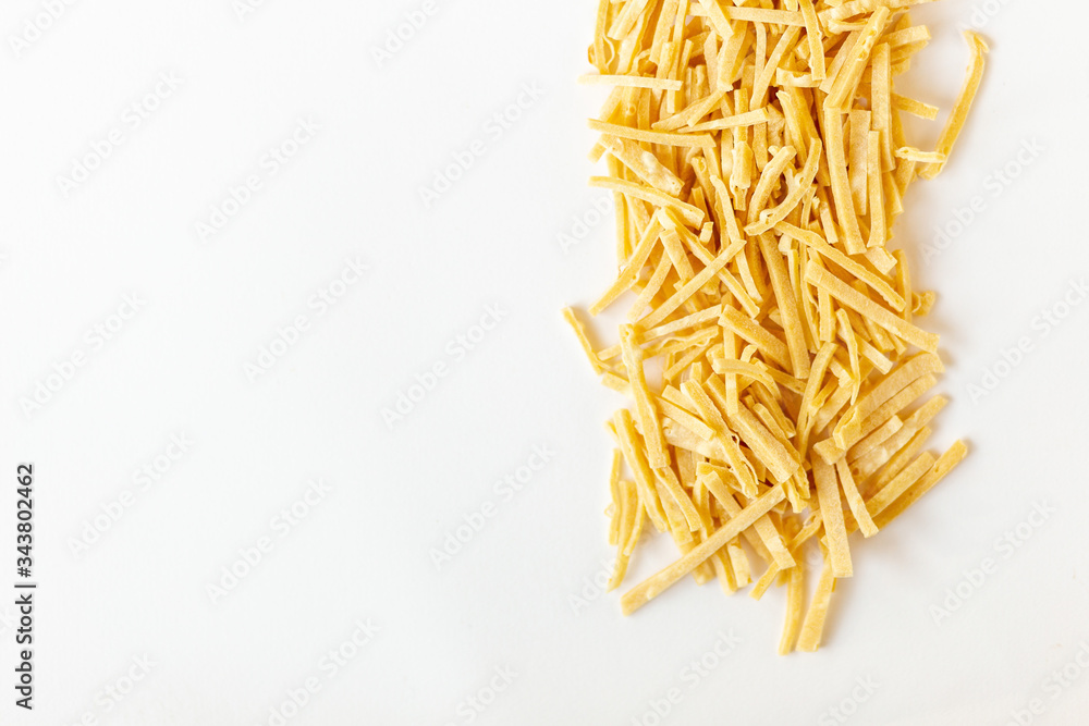 Fototapeta premium Delicious freshly house made pasta to dry on a white background copy past mockup