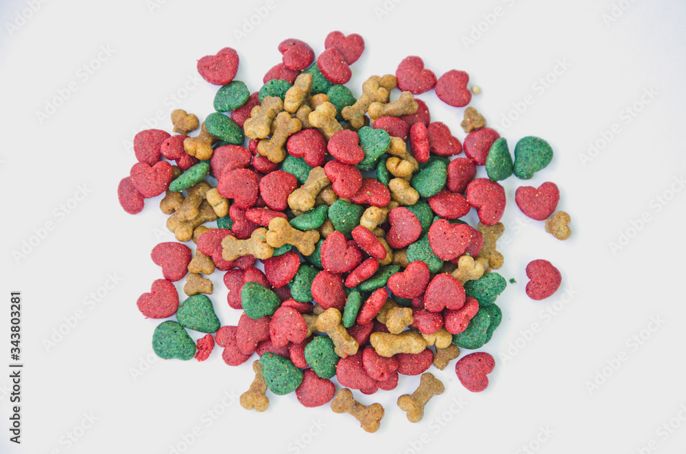 Bone and heart shape of dog food on white background Bone and heart shape of dog food on white background