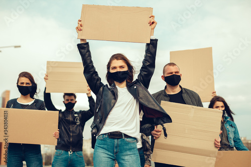 A group of people with mask and posters to protest The protest of the population against coronavirus and against the introduction of quarantine Meeting about coronavirus and people rights. copyspace photo