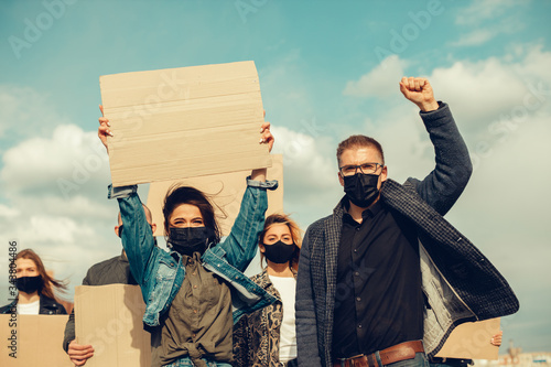 A group of people with mask and posters to protest The protest of the population against coronavirus and against the introduction of quarantine Meeting about coronavirus and people rights. copyspace photo