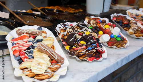 Street food dessert: waffles and small dutch pancakes
