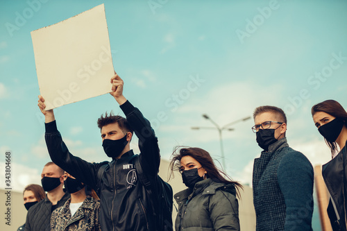 A group of people with mask and posters to protest The protest of the population against coronavirus and against the introduction of quarantine Meeting about coronavirus and people rights. copyspace photo