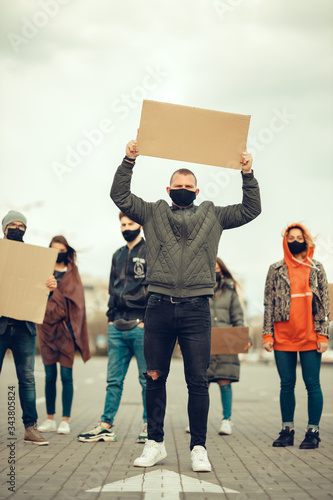 A group of people with mask and posters to protest The protest of the population against coronavirus and against the introduction of quarantine Meeting about coronavirus and people rights. copyspace photo