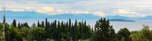 Fototapeta Naklejka Na Ścianę i Meble -  panoramic land and sea with olive and cypress tree forests islands and mountains in corfu greece