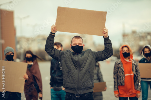 A group of people with mask and posters to protest The protest of the population against coronavirus and against the introduction of quarantine Meeting about coronavirus and people rights. copyspace photo