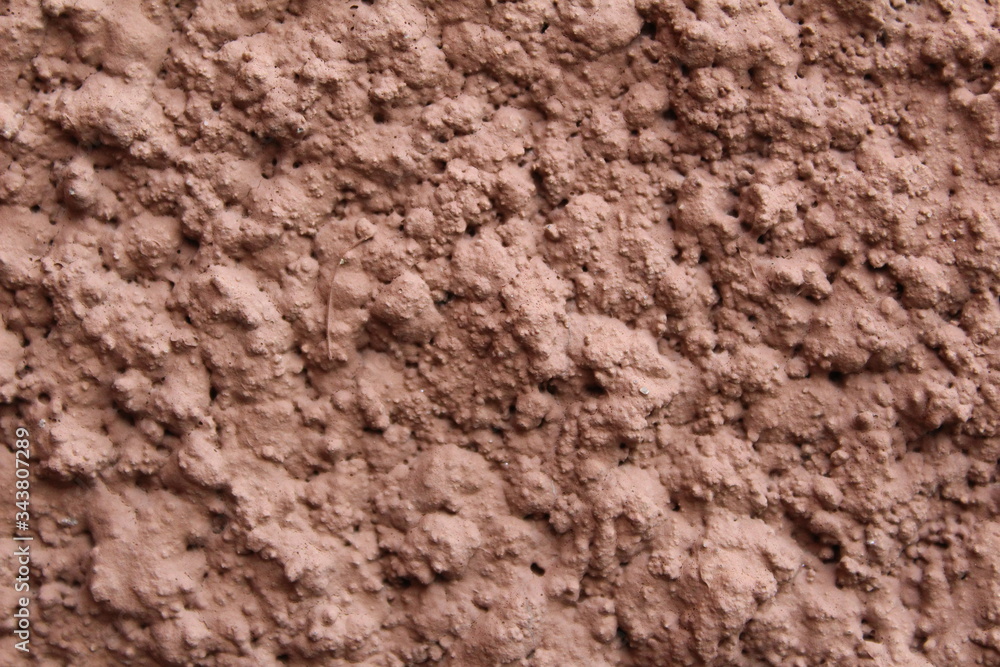wall with a modern coating of brown clay plaster wall with a modern coating of brown clay plaster