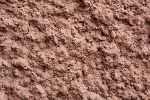 wall with a modern coating of brown clay plaster