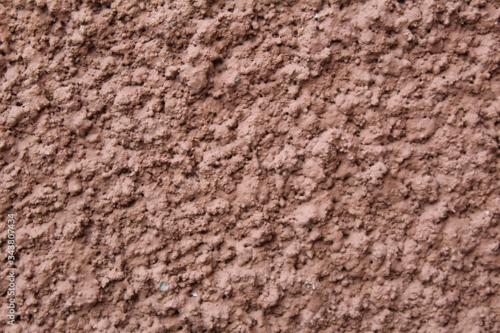 wall with a modern coating of brown clay plaster