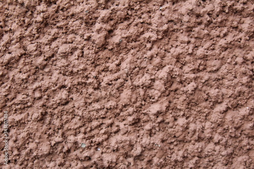 wall with a modern coating of brown clay plaster