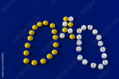The tablets which are laid out in the form of lungs. Yellow and white drugs on a blue background