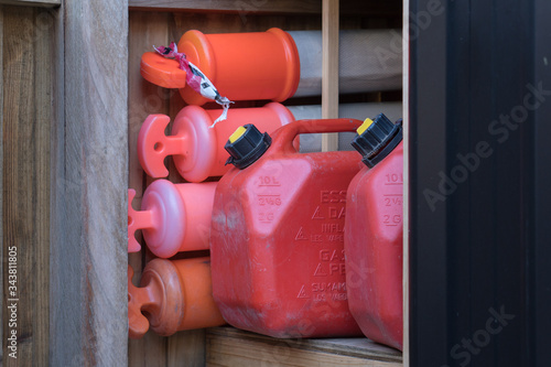 jerry can fuel container and traffic cones in a backyard