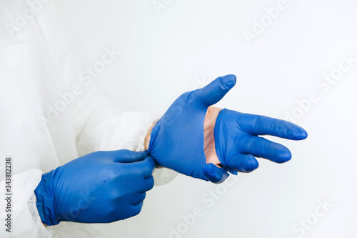 doctor's hands close-up in torn rubber gloves. torn medical gloves after a working day at the clinic. Doctors are battling coronavirus epidemic. Covid-2019
