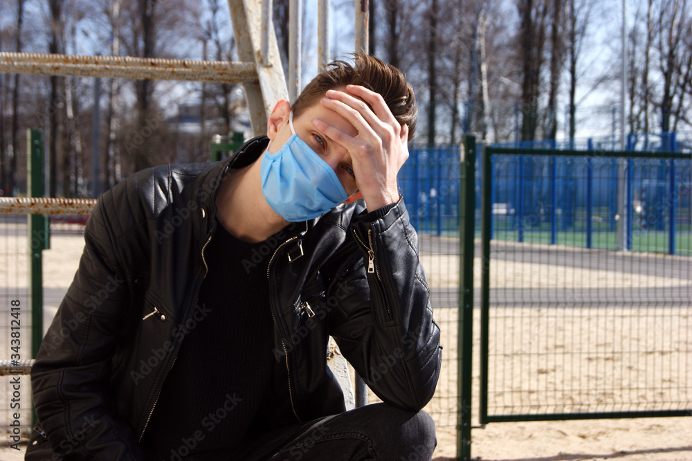 The image face of a young man wearing a mask to prevent germs, toxic fumes, and dust. The image face of a young man wearing a mask to prevent germs, toxic fumes, and dust.