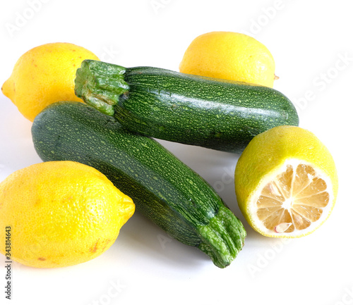 zucchini and lemons on a white background. Vitamins Vegetables.