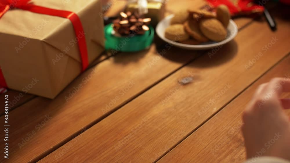 holidays, new year and christmas concept - hands stacking packed gift boxes on wooden table holidays, new year and christmas concept - hands stacking packed gift boxes on wooden table