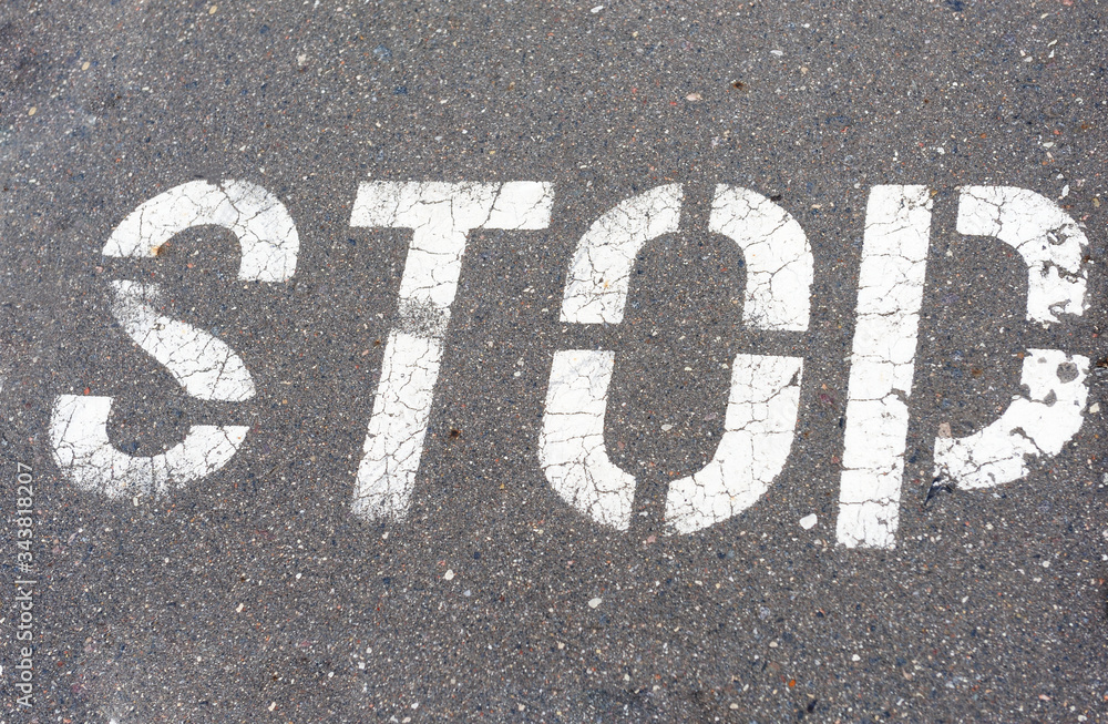 Word Stop written on an asphalt road, Stop Sign
Word Stop written on an asphalt road, Stop Sign