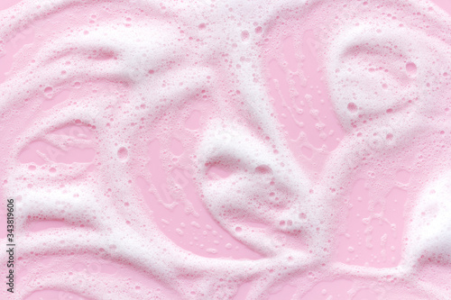 soap foam on pink background, macro lather texture