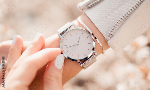 Beautiful elegant white watch on woman hand. Close-up photo. photo