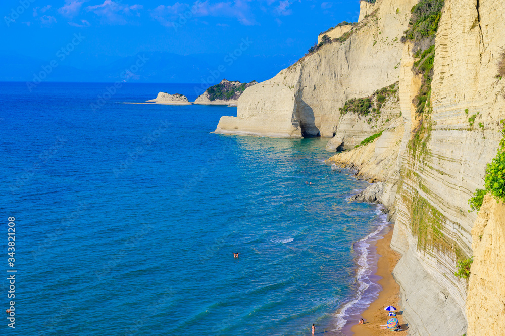 Loggas beach at Peroulades is a paradise beach at  high rocky white cliff and crystal clear azure water in Corfu, close to Cape Drastis, Ionian island, Greece, Europe