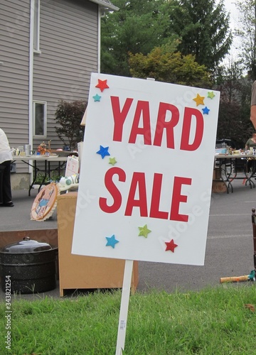 A jaunty Yard Sale sign invites passersby to shop for bargains
