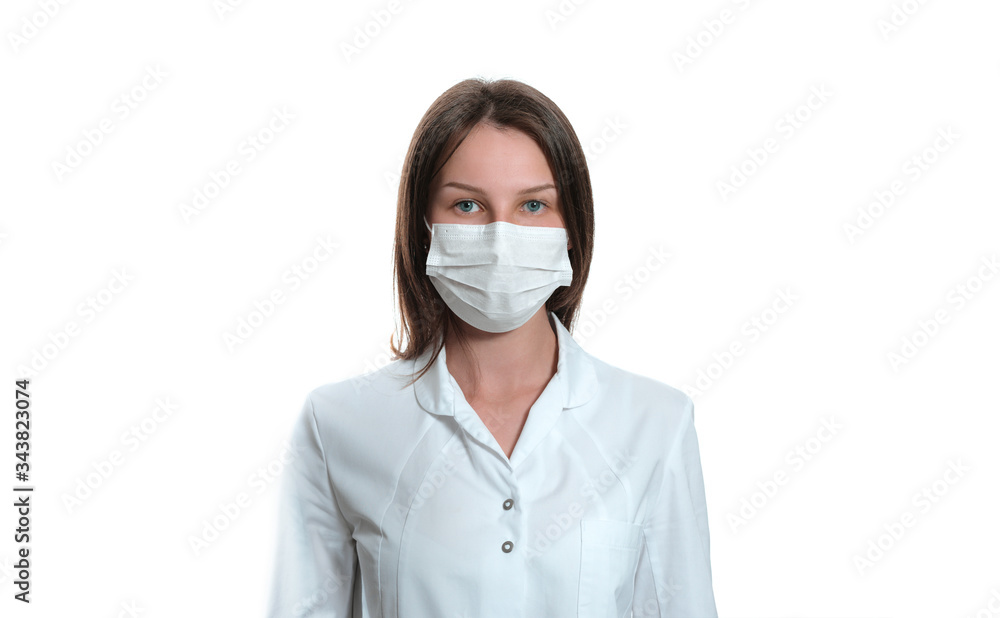 Young female nurse on camera wearing a surgical or medical mask. Doctor wearing a white coat isolated on white background. covid 19, coronavirus, quarantine Young female nurse on camera wearing a surgical or medical mask. Doctor wearing a white coat isolated on white background. covid 19, coronavirus, quarantine