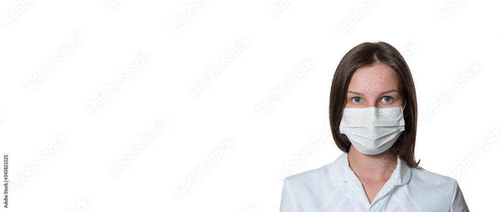 Young female nurse on camera wearing a surgical or medical mask. Doctor wearing a white coat isolated on white background. covid 19, coronavirus, quarantine, banner Young female nurse on camera wearing a surgical or medical mask. Doctor wearing a white coat isolated on white background. covid 19, coronavirus, quarantine, banner