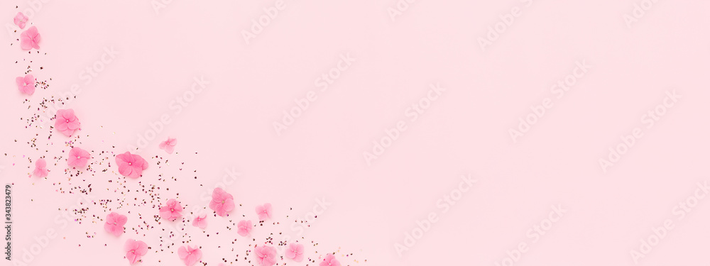 Banner with flowers and gold glitter confetti splash on pink background. Spring Holidays, Birthday, Mothers Day, wedding. Copy space. Banner with flowers and gold glitter confetti splash on pink background. Spring Holidays, Birthday, Mothers Day, wedding. Copy space.