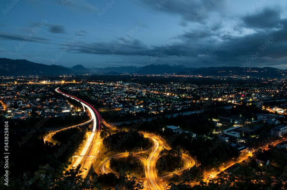 Slip road at night with view over town, long exposure, Gebhardsberg, Austria, Europe