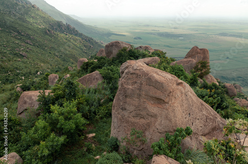 Big reddish boulders and trees on Kajulu hills with view of mountain slope, Kisumu, Kenya, Africa photo