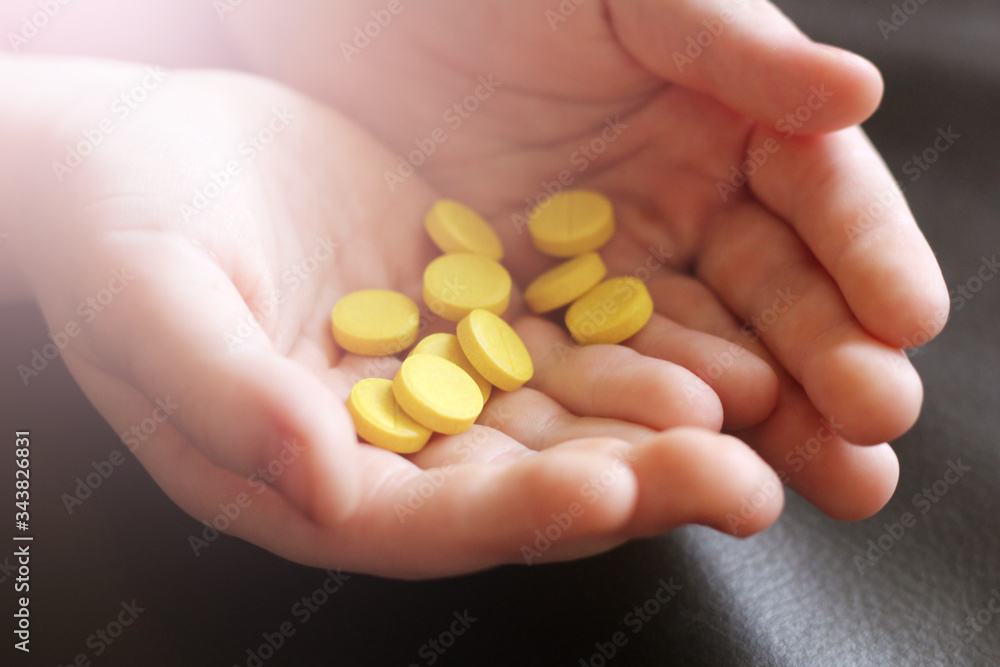 Yellow tablets in children's hands Yellow tablets in children's hands