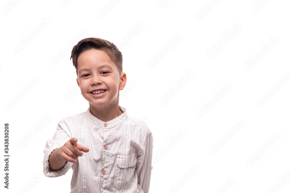 Shot of a little smiling boy pointing at something, isolated Shot of a little smiling boy pointing at something, isolated