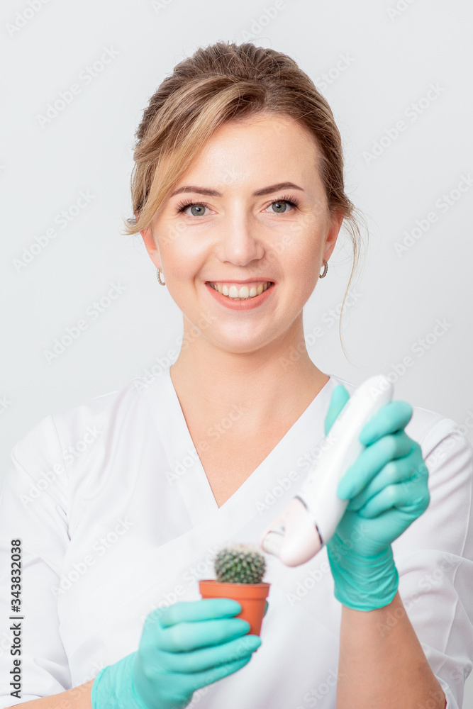 Cosmetologist is shaving green cactus with electric epilator smiling on white background. Cosmetologist is shaving green cactus with electric epilator smiling on white background.