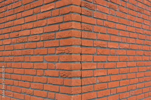 The corner of an orange brick wall texture