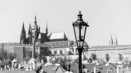 Vintage street lamp on Charles Bridge. Prague Castle out of focus on the background. Prague, Czech Republic