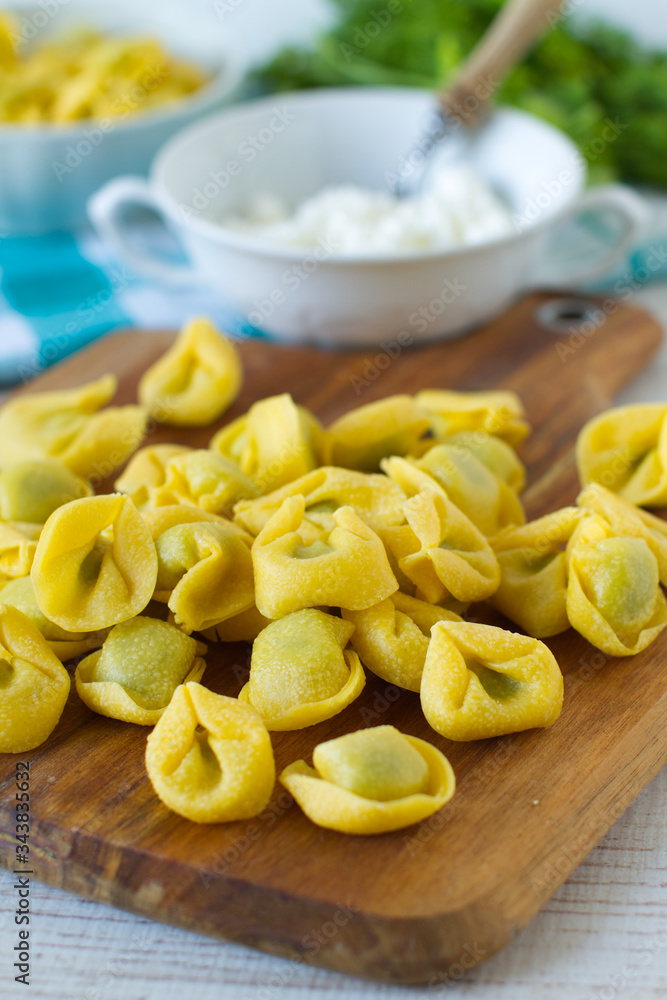 
Fresh spinach and ricotta tortellini on a rustic table