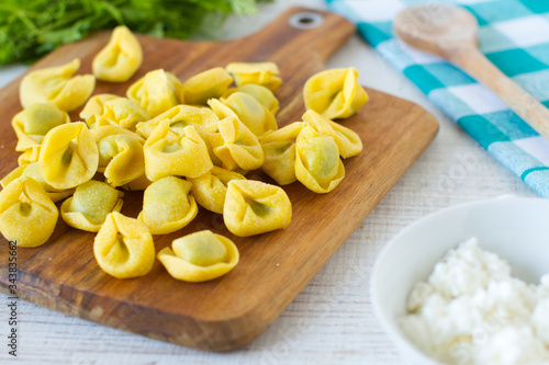  Fresh spinach and ricotta tortellini on a rustic table