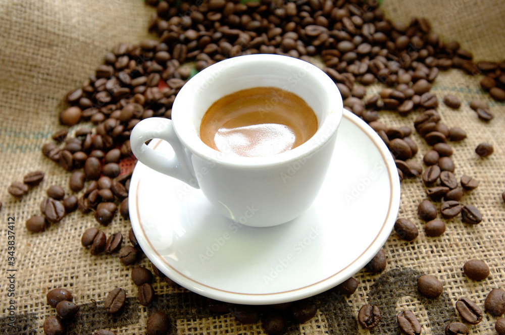 italian espresso coffee cup on a jute canvas and with coffee beans italian espresso coffee cup on a jute canvas and with coffee beans