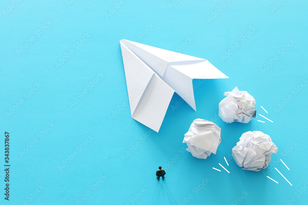 education or innovation concept. paper origami plane over blue background