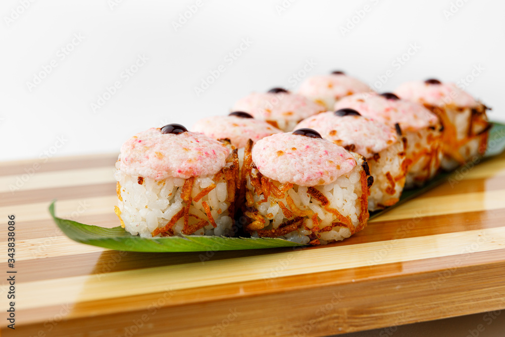 Maki Sushi Rolls set on wooden bamboo board. Japanese traditional Cuisine. White background. Maki Sushi Rolls set on wooden bamboo board. Japanese traditional Cuisine. White background.
