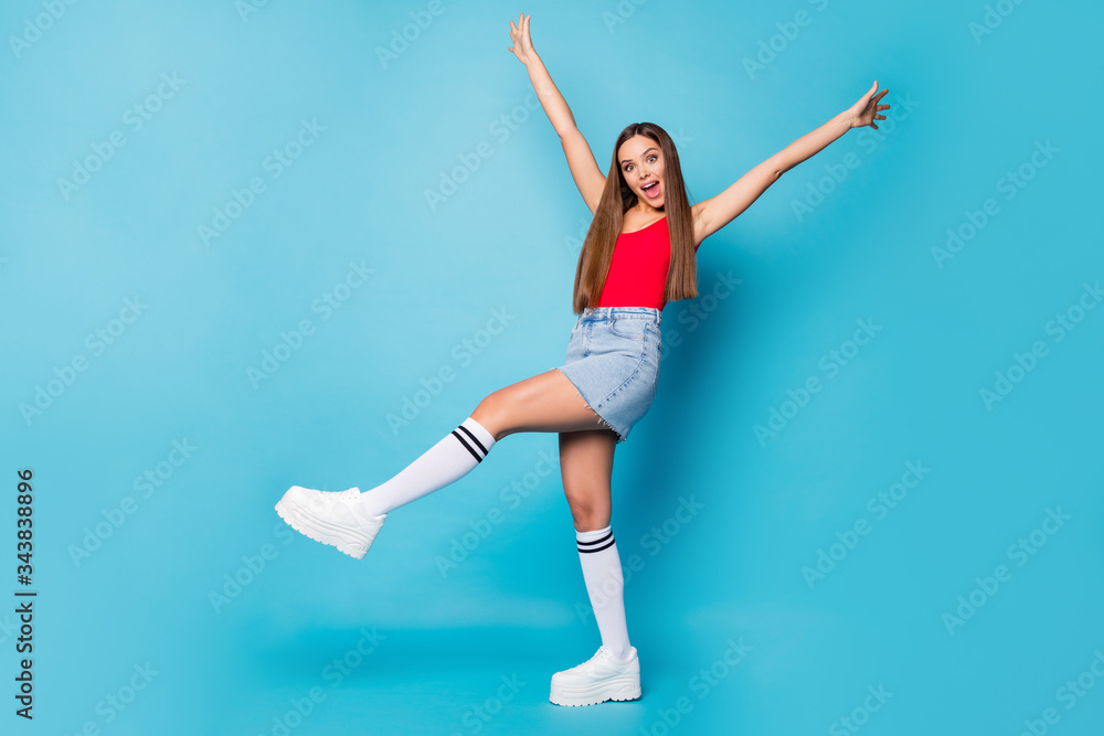 Full size photo astonished girl walk go spring holiday free time have slippery road fall scream omg raise hands arms legs wear good look tank-top footwear isolated blue color background Full size photo astonished girl walk go spring holiday free time have slippery road fall scream omg raise hands arms legs wear good look tank-top footwear isolated blue color background