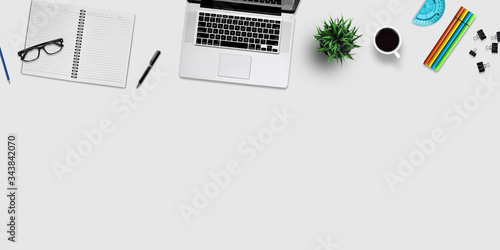 Top view education desk and supplies, with copy space. Creative flat lay photo of workspace desk/Panoramic banner gray background