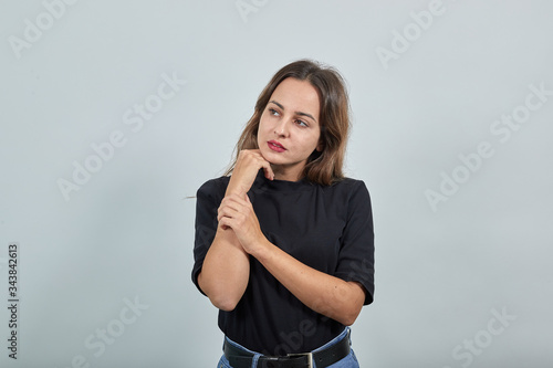 Fotografija Young brunette lady in black t-shirt on grey background cute beautiful woman gen