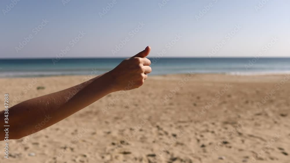 Sand as the time slips through your fingers. girl holding a sand sea background. from the hands of a girl pouring sand on the beach. Sand in your hands. Concept of vacation and trip to the sea. Sand as the time slips through your fingers. girl holding a sand sea background. from the hands of a girl pouring sand on the beach. Sand in your hands. Concept of vacation and trip to the sea.