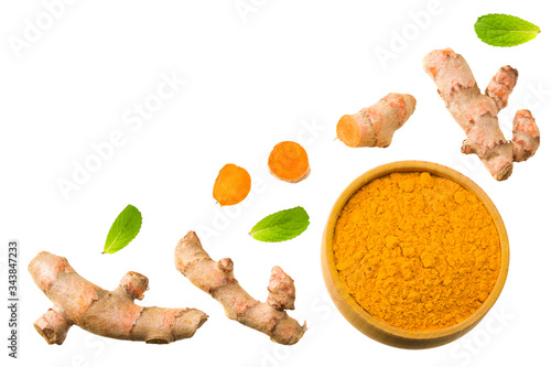 Turmeric powder with turmeric root isolated on white background. Top view.