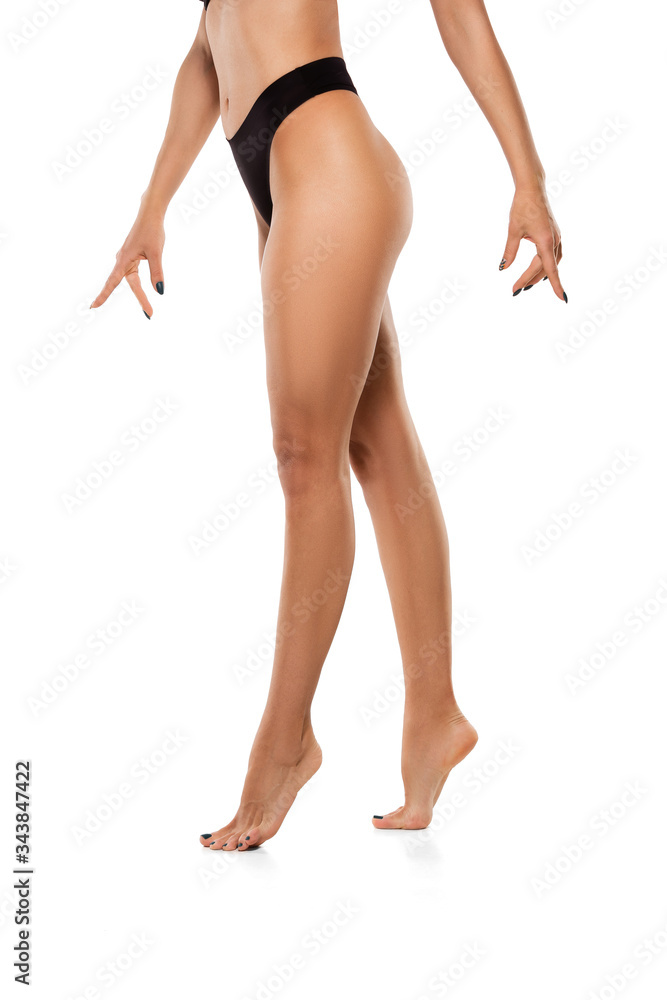 Beautiful female legs, buttlocks and belly isolated on white background. Beauty, cosmetics, spa, depilation, treatment and fitness concept. Sportive, sensual body with well-kept skin in underwear. Beautiful female legs, buttlocks and belly isolated on white background. Beauty, cosmetics, spa, depilation, treatment and fitness concept. Sportive, sensual body with well-kept skin in underwear.