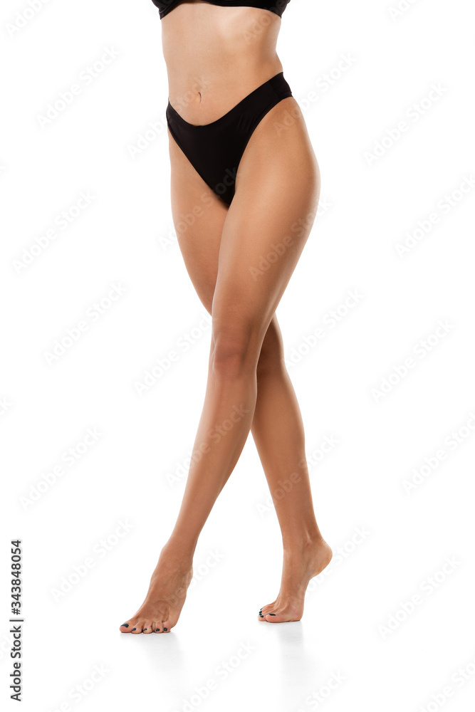 Beautiful female legs, buttlocks and belly isolated on white background. Beauty, cosmetics, spa, depilation, treatment and fitness concept. Sportive, sensual body with well-kept skin in underwear. Beautiful female legs, buttlocks and belly isolated on white background. Beauty, cosmetics, spa, depilation, treatment and fitness concept. Sportive, sensual body with well-kept skin in underwear.